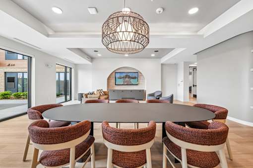 A modern dining room with a large table and chairs.