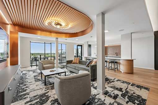 A modern living room with a curved wooden ceiling and a large grey sofa.