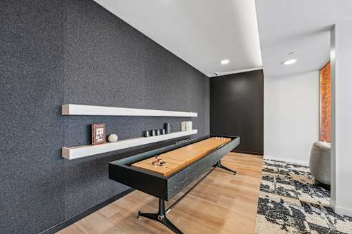 A shelf with a billiard ball and cue on it.
