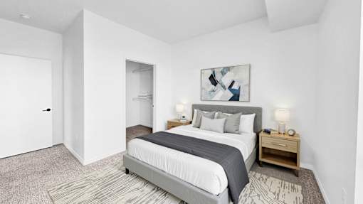 A bedroom with a large bed and a painting on the wall.