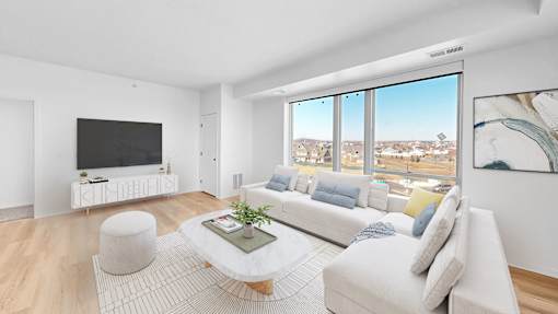 A modern living room with a large window overlooking a cityscape.