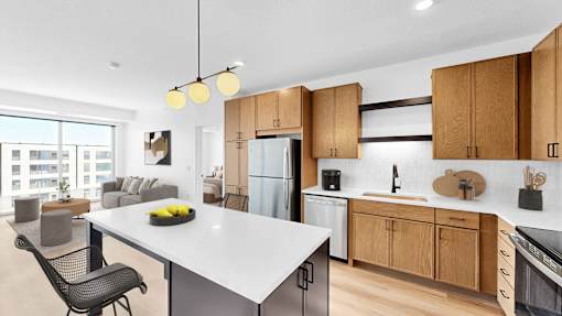 A modern kitchen with wooden cabinets and a white island.