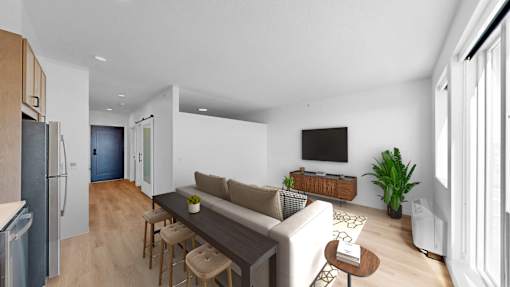 A modern living room with a couch, a coffee table, and a television.