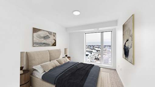 A bedroom with a large bed and two framed pictures on the wall.