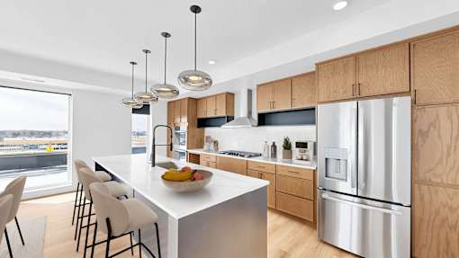 A modern kitchen with a large island and stainless steel appliances.