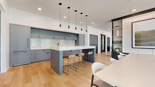 A modern kitchen with a large island and bar stools.