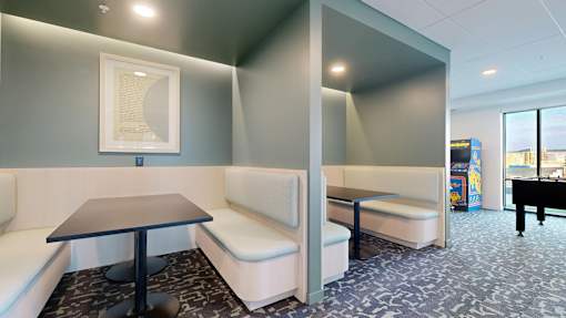 A room with a table and two couches.