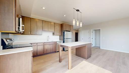 A modern kitchen with wooden cabinets and a central island.