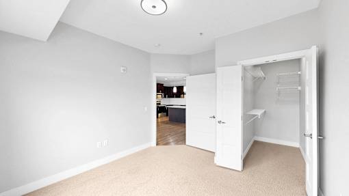 A white room with a doorway leading to another room.