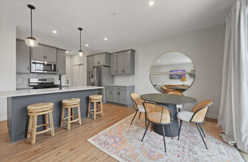 a kitchen and dining area with a round table and stools