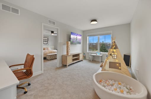 a play room with a christmas tree and a bath tub