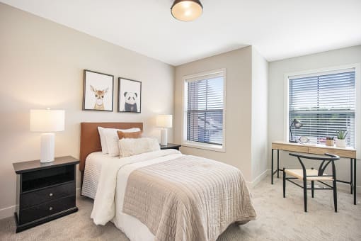 a bedroom with a bed and a desk with a window