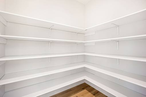 Empty white shelves in a room.