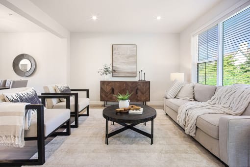 a living room with couches and chairs and a table