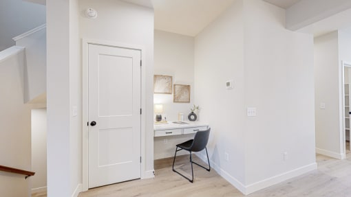 a bedroom with a desk and a door