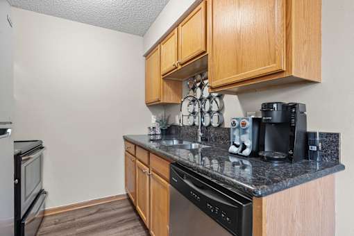 Kitchen with Wooden Cabinets at Granite Peaks Apartments, Minneapolis, 55429