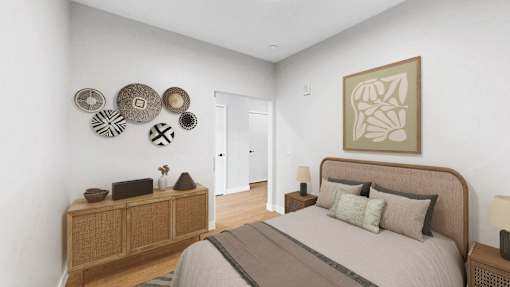 A bedroom with a bed, nightstand, and a wall decorated with circular artworks.