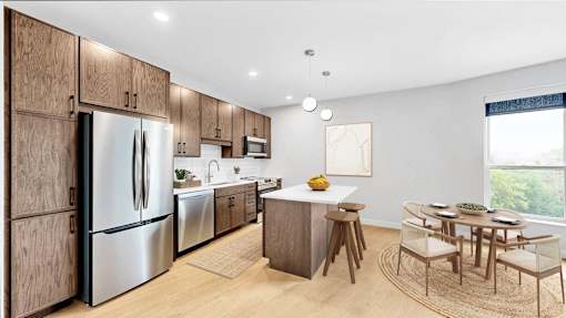 A modern kitchen with wooden cabinets and stainless steel appliances.
