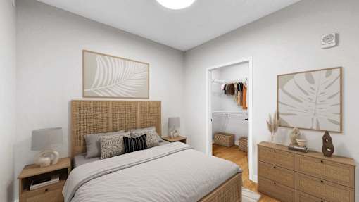 A bedroom with a large bed, a nightstand, and a dresser with a mirror.