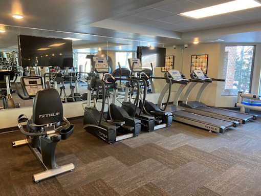 Fitness center with cardio machines at Aspenwood Apartments, MN, 55123