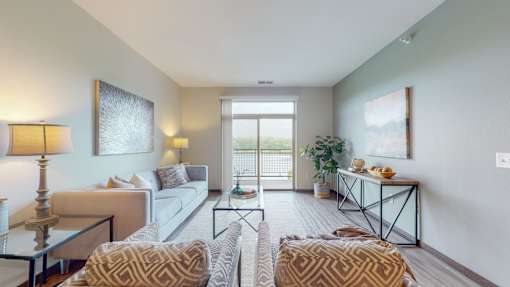 a living room with a sliding glass door leading to a balconyat Lake Jonathan Flats, Chaska, MN