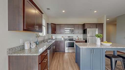 A kitchen with brown cabinets and a granite countertop. at Lake Jonathan Flats, Minnesota, 55318