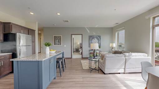 A modern kitchen with a blue island and white appliances. at Lake Jonathan Flats, Minnesota, 55318