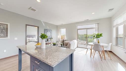 A kitchen with a large island and a dining table with chairs. at Lake Jonathan Flats, Minnesota