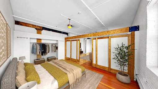 A bedroom with a bed and a potted plant.