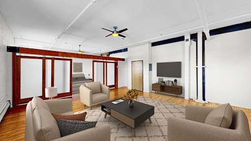 A living room with a brown sofa, a grey armchair, a coffee table, and a television.