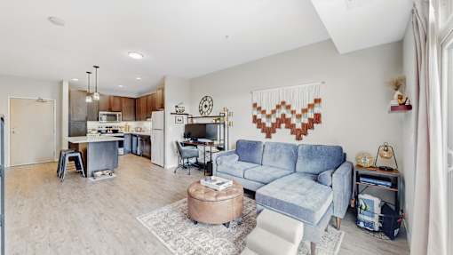 A living room with a blue couch and a coffee table.