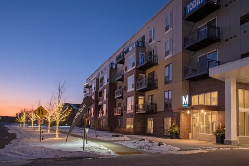 Exterior view of entrance with festive winter lights on the trees at The McMillan