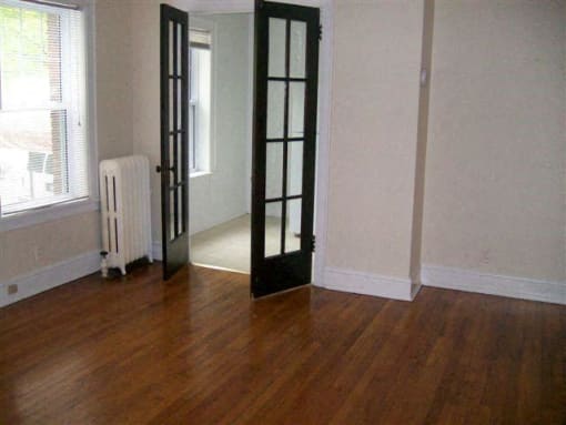 a room with a wood floor and a black door