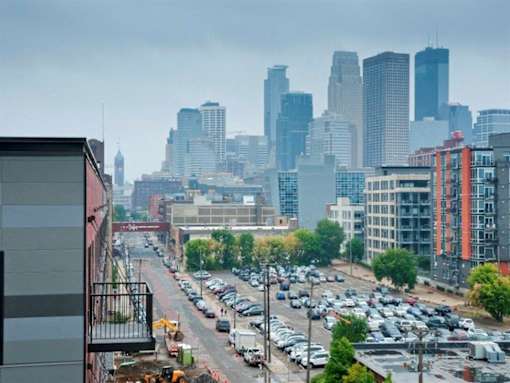 A city street with cars and buildings in the background.