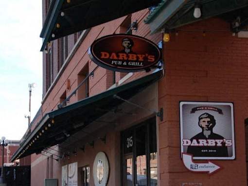 A red brick building with a sign that says Darby's.