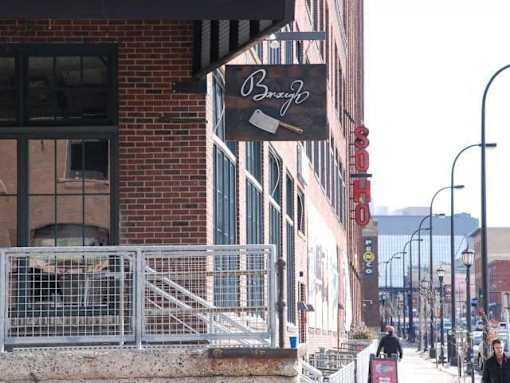 A street view with a building that has a sign that says "Bonzo".