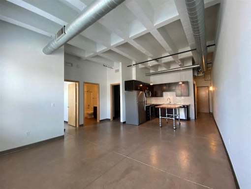 A large open room with a kitchen area in the background.at Gurley Lofts, Minneapolis, MN