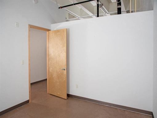 A room with a brown door and white walls.at Gurley Lofts, Minnesota, 55401