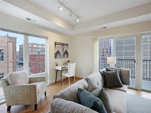 A living room with a couch, chair, and a desk.at Third North Apartments, Minnesota