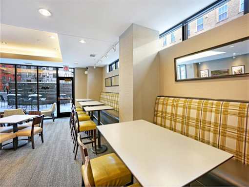 A restaurant with tables and chairs and a window overlooking the street.at Third North Apartments, Minnesota