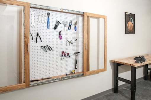 A wall-mounted pegboard with various tools hanging on it.at Third North Apartments, Minneapolis, MN