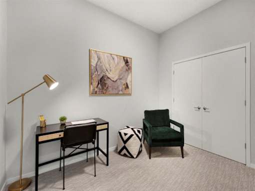 A room with a desk, chair, and painting on the wall.at Viridium Apartments, Minnesota 