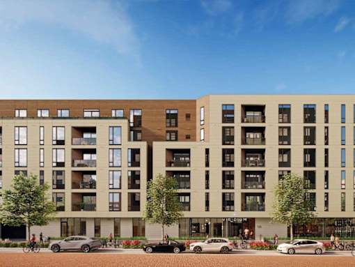 A modern apartment building with cars parked in front.at Viridium Apartments, Minneapolis, MN 