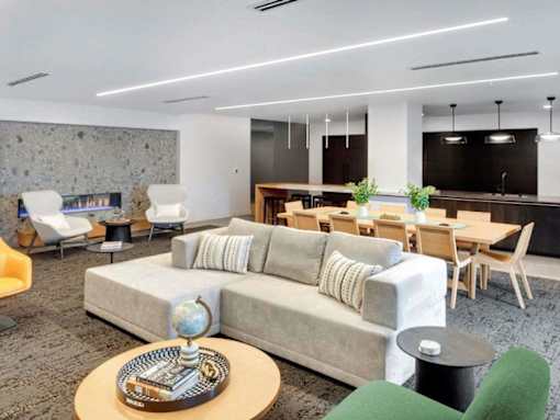 A modern living room with a grey sofa and a wooden coffee table.at Viridium Apartments, Minneapolis, MN 