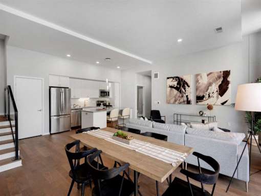 A modern kitchen with a dining table and chairs.at Viridium Apartments, Minneapolis, MN 55401 