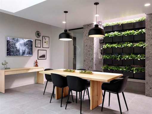 A modern dining room with a wooden table and black chairs.at Viridium Apartments, Minneapolis, MN 55401 