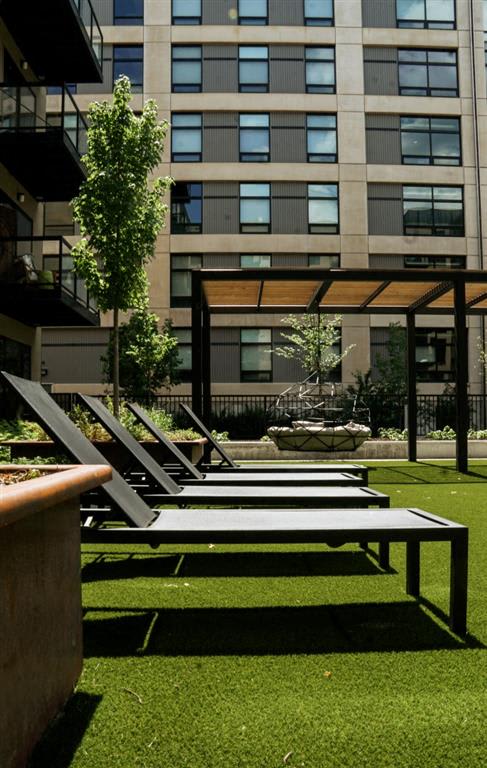A modern outdoor seating area with a bench and a table.at Viridium Apartments, Minneapolis 