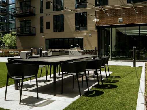 A black table and chairs are set up on a patio.at Viridium Apartments, Minneapolis, 55401 