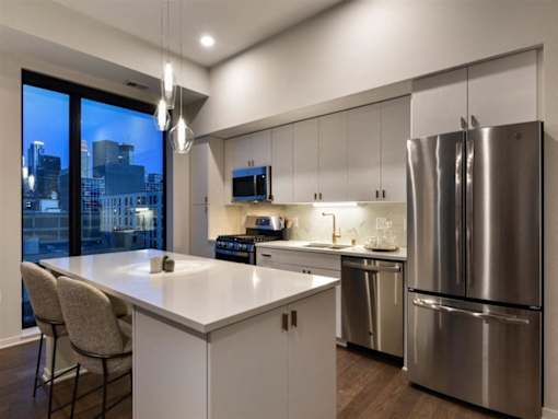 A modern kitchen with a large island and stainless steel appliances.at Viridium Apartments, Minneapolis, MN 