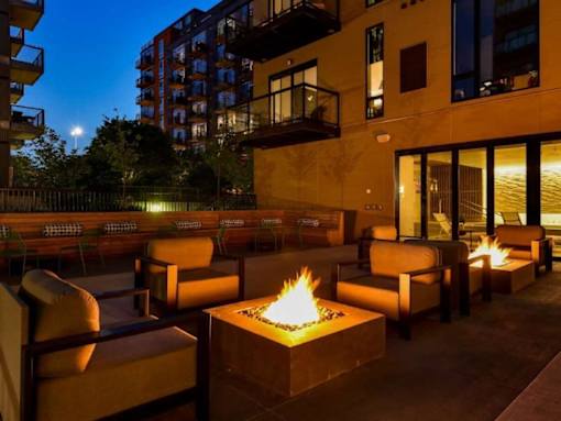 A patio with a fire pit and chairs.at Viridium Apartments, Minneapolis, 55401 
